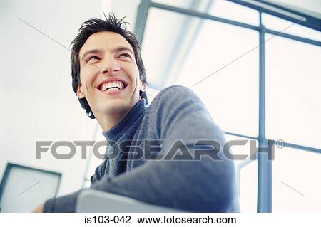Stock Image - Portrait of a laughing businessman. Fotosearch