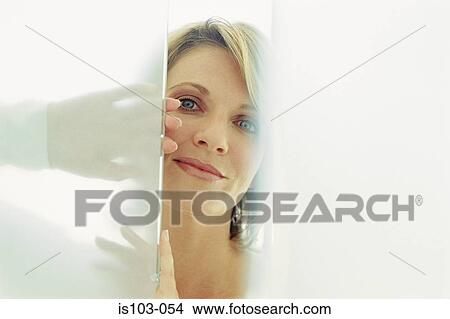 Picture - Portrait of a partially concealed businesswoman. Fotosearch