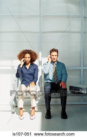 Businessman and businesswoman talking on cellphones View Large Photo Image Stock Image - Businessman and businesswoman talking on cellphones. Fotosearch