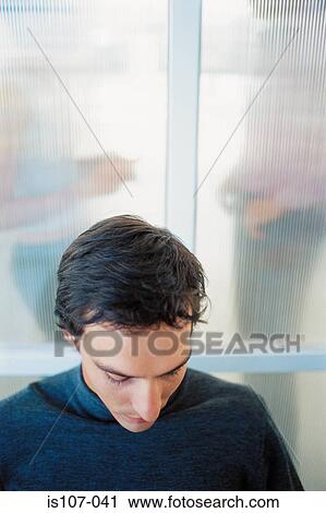 Stock Image - Businessman looking downcast. Fotosearch