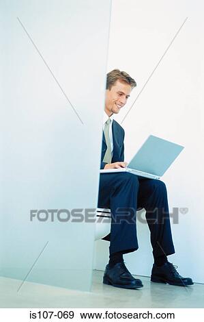 Businessman seated on toilet with laptop computer View Large Photo Image Stock Photo - Businessman seated on toilet with laptop computer. Fotosearch