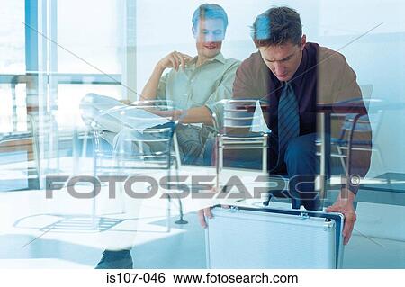 Stock Photograph - Businessmen behind glass pane. Fotosearch
