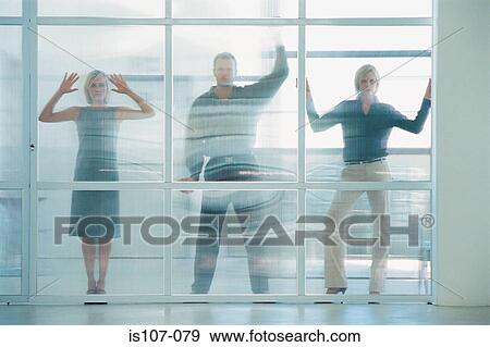 Businesspeople behind glass pane View Large Photo Image Stock Photo - Businesspeople behind glass pane. Fotosearch