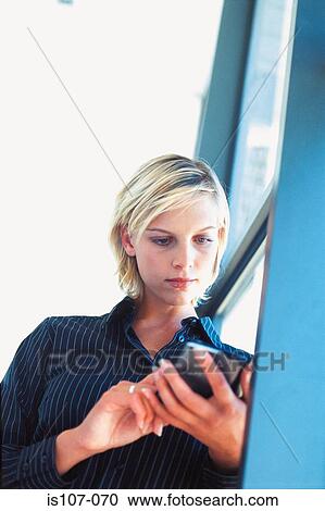 Stock Image - Businesswoman with personal organiser. Fotosearch