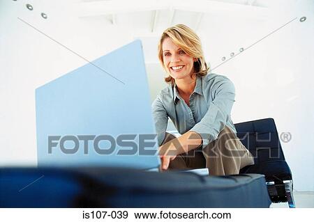 Businesswoman working on laptop computer View Large Photo Image Stock Photo - Businesswoman working on laptop computer. Fotosearch