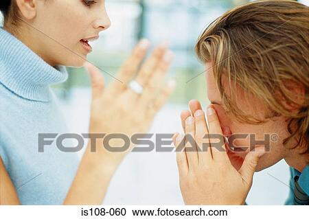 Stock Image - Businessman and businesswoman in discussion. Fotosearch