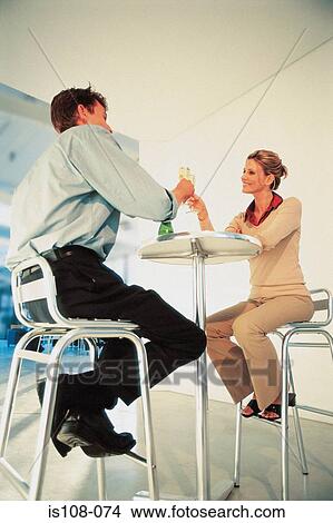 Businessman and businesswoman proposing a toast View Large Photo Image Picture - Businessman and businesswoman proposing a toast. Fotosearch