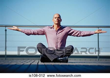 Stock Image - Businessman meditating. Fotosearch
