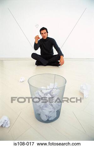 Stock Photo - Businessman throwing paper into bin. Fotosearch