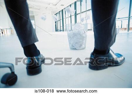 Businessman throwing paper into bin View Large Photo Image Stock Photo - Businessman throwing paper into bin. Fotosearch