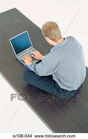 Businessman working on table View Large Photo Image Picture - Businessman working on table. Fotosearch