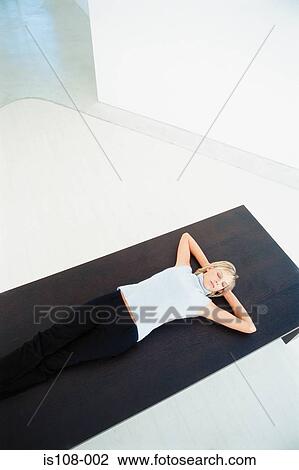 Stock Image - Businesswoman relaxing on table. Fotosearch