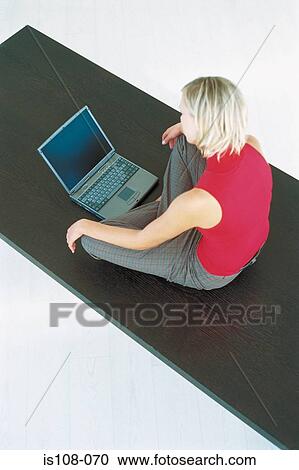 Stock Image - Businesswoman working on table. Fotosearch