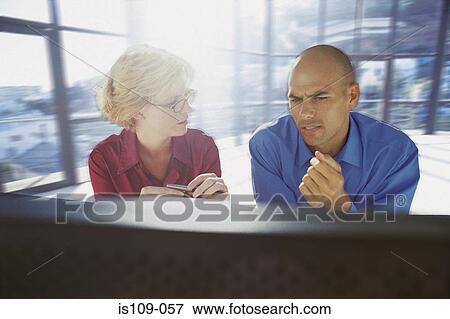 Businessman and businesswoman in office View Large Photo Image Stock Photo - Businessman and businesswoman in office. Fotosearch