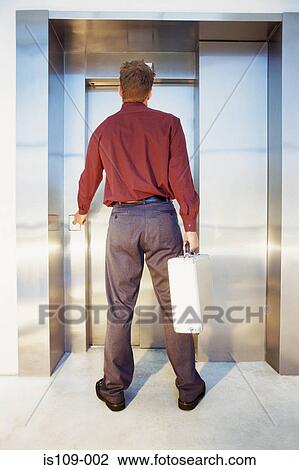 Businessman waiting for elevator View Large Photo Image Stock Image - Businessman waiting for elevator. Fotosearch