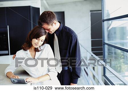 Man and woman cuddling in office View Large Photo Image Stock Photo - Man and woman cuddling in office. Fotosearch