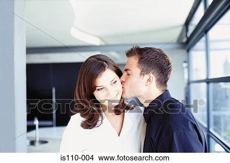 Man and woman kissing in office View Large Photo Image Picture - Man and woman kissing in office. Fotosearch