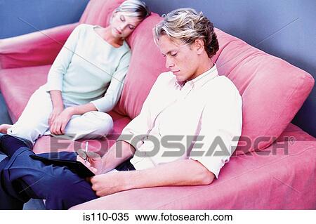 Man and woman relaxing on sofa View Large Photo Image Stock Photography - Man and woman relaxing on sofa. Fotosearch