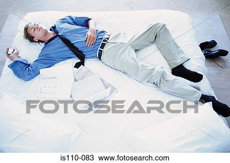 Man lying on bed View Large Photo Image Stock Image - Man lying on bed. Fotosearch