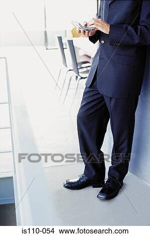 Man typing on personal organiser View Large Photo Image Picture - Man typing on personal organiser. Fotosearch