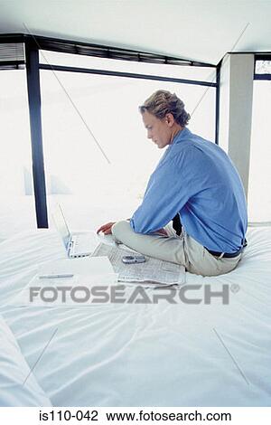 Man working on bed View Large Photo Image Stock Image - Man working on bed. Fotosearch
