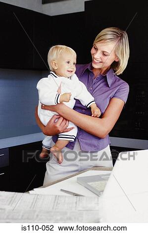Woman and infant in kitchen View Large Photo Image Stock Image - Woman and infant in kitchen. Fotosearch