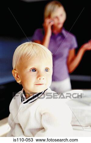 Woman and infant in kitchen View Large Photo Image Stock Image - Woman and infant in kitchen. Fotosearch