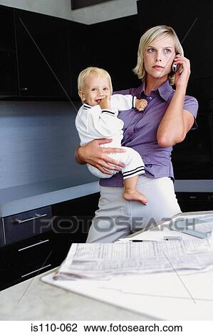 Woman and infant in kitchen View Large Photo Image Stock Image - Woman and infant in kitchen. Fotosearch