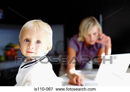 Woman and infant in kitchen View Large Photo Image Stock Photo - Woman and infant in kitchen. Fotosearch
