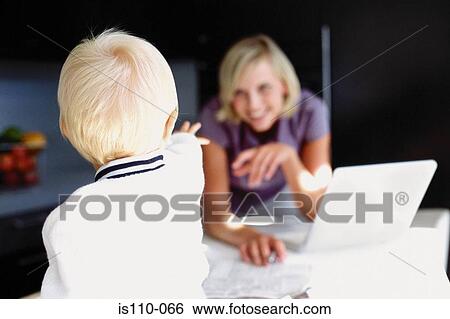 Woman and infant in kitchen View Large Photo Image Stock Photograph - Woman and infant in kitchen. Fotosearch