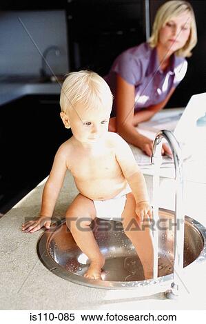 Woman and infant in kitchen View Large Photo Image Stock Photography - Woman and infant in kitchen. Fotosearch