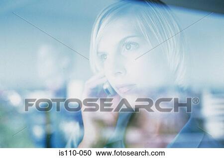 Woman using cellphone behind glass pane View Large Photo Image Stock Image - Woman using cellphone behind glass pane. Fotosearch