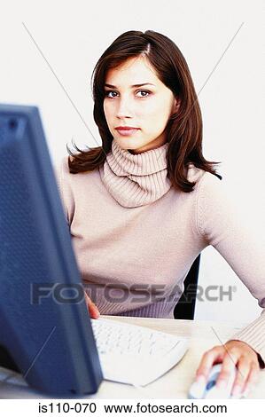 Stock Image - Woman working on computer. Fotosearch