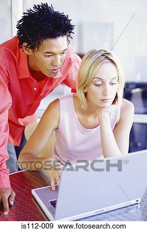 Man and woman using laptop computer View Large Photo Image Stock Photo - Man and woman using laptop computer. Fotosearch