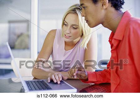 Man and woman using laptop computer View Large Photo Image Stock Photograph - Man and woman using laptop computer. Fotosearch