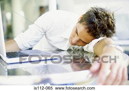 Stock Photography - Man asleep on table. Fotosearch