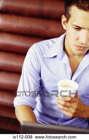 Man drinking and working in cafe View Large Photo Image Stock Photo - Man drinking and working in cafe. Fotosearch