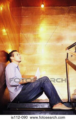 Man sitting on stairway View Large Photo Image Stock Image - Man sitting on stairway. Fotosearch