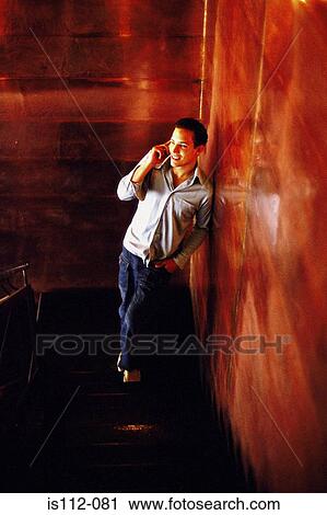 Man talking on cellphone View Large Photo Image Stock Image - Man talking on cellphone. Fotosearch