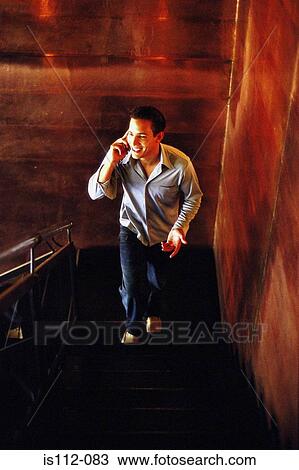 Man talking on cellphone View Large Photo Image Stock Image - Man talking on cellphone. Fotosearch