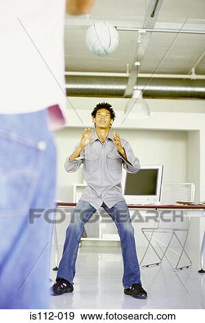 Men playing with ball in an office View Large Photo Image Stock Photo - Men playing with ball in an office. Fotosearch