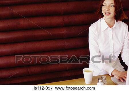 Woman having breakfast and working View Large Photo Image Stock Photo - Woman having breakfast and working. Fotosearch