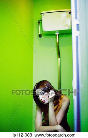 Woman sitting on lavatory View Large Photo Image Stock Photo - Woman sitting on lavatory. Fotosearch