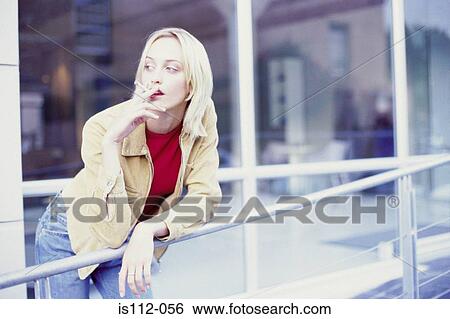 Stock Photograph - Woman smoking cigarette. Fotosearch