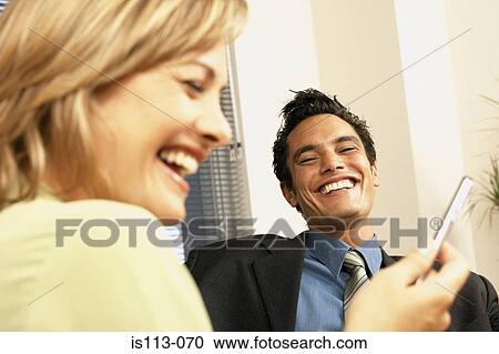 Stock Image - Businessman and businesswoman joking. Fotosearch