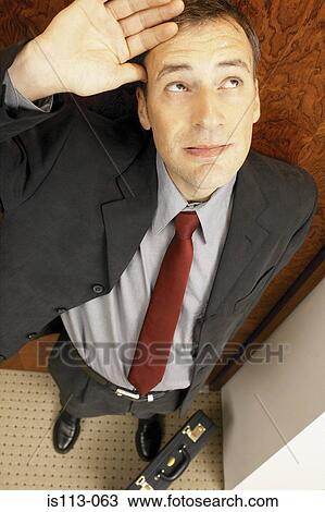 Businessman looking upwards View Large Photo Image Stock Image - Businessman looking upwards. Fotosearch