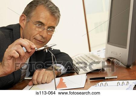 Businessman playing with executive toy View Large Photo Image Picture - Businessman playing with executive toy. Fotosearch