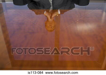 Businessman reflected in glass table View Large Photo Image Picture - Businessman reflected in glass table. Fotosearch