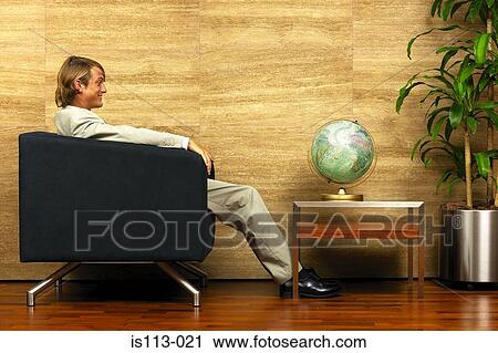 Businessman watching a globe View Large Photo Image Stock Image - Businessman watching a globe. Fotosearch