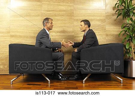 Stock Photo - Businessmen shaking hands. Fotosearch
